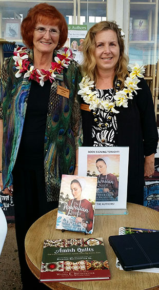 Wanda signing books in Kauai, Hawaii with co-author, Jean.